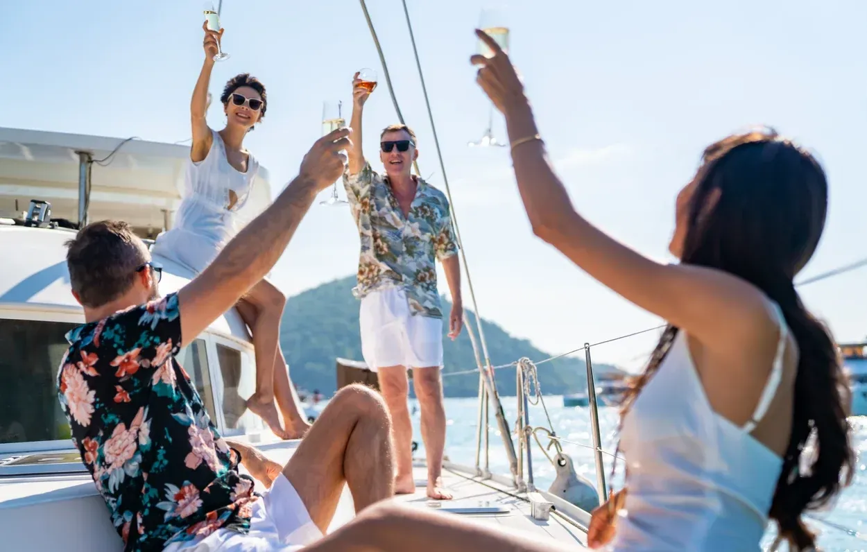 A group raising a toast on the deck of a yacht