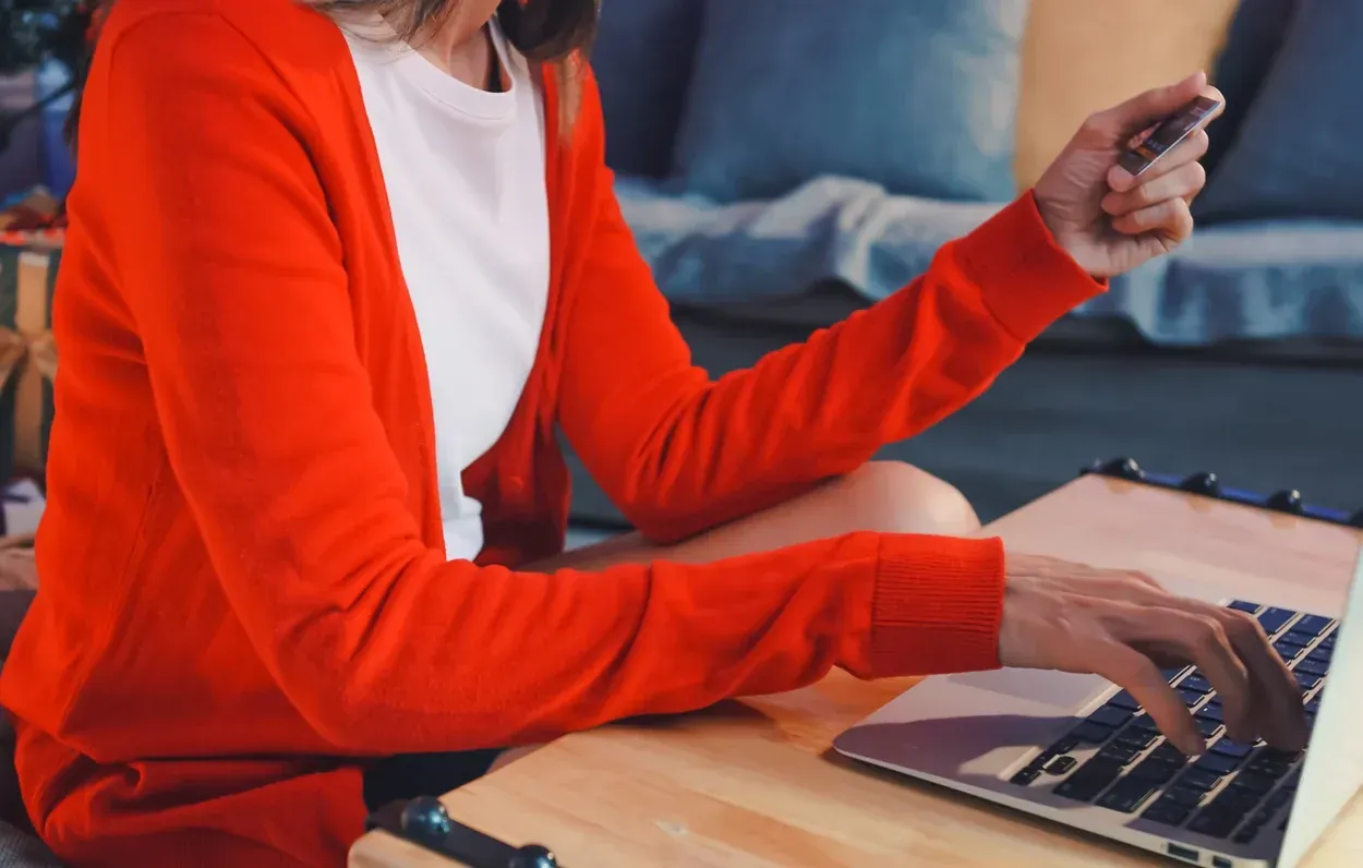 Shopping on a laptop, card in hand